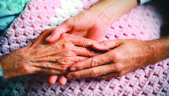 Holding Hands with Elderly Patient --- Image by © Wernher Krutein/Corbis